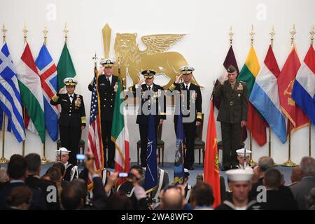 US military forces. 171020XT273-291 NAPLES, Italy (Oct. 20, 2017) Distinguished guests salute the American flag during  a change of command ceremony held at the Allied Joint Force Command auditorium in Naples, Italy, Oct. 20, 2017. During the ceremony, Adm. James Foggo III relieved Adm. Michelle Howard as commander, Allied Joint Force Command Naples and commander, U.S. Naval Forces Europe-Africa. U.S. Naval Forces Europe-Africa, headquartered in Naples, Italy, oversees joint and naval operations, often in concert with allied, joint, and interagency partners, to enable enduring relationships an Stock Photo