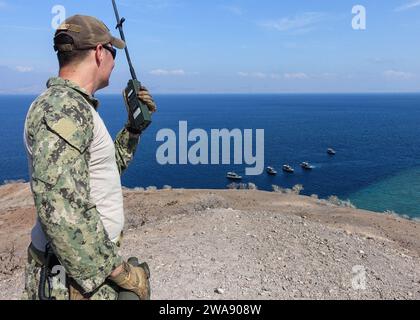 US military forces. 180117FD185-400 GULF OF TADJOURA, Djibouti (Jan. 18, 2018) Chief Boatswain’s Mate Scott Tatum, assigned to Coastal Riverine Squadron (CRS) 10, range safety officer, watches as tactical patrol crafts line up for an underway gun shoot in the Gulf of Tadjoura, Djibouti, Jan. 18, 2018. CRS-10 is forward-deployed to the U.S. 6th Fleet area of operations and conducts joint and naval operations, often in concert with allied and interagency partners, in order to advance U.S. national interests and security and stability in Europe and Africa. (U.S. Navy photo by Engineman Second 2nd Stock Photo