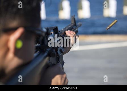 US military forces. BAY OF CADIZ (Jan. 19, 2018) Cryptologic Technician (Maintenance) 1st Class Ryan Davidson fires an M4 rifle during a small-arms gun shoot on the flight deck of the Arleigh Burke-class guided-missile destroyer USS Ross (DDG 71), Jan. 19, 2018. Ross, forward-deployed to Rota, Spain, is on its sixth patrol in the U.S. 6th Fleet area of operations in support of regional allies and partners and U.S. national security interests in Europe. (U.S. Navy photo by Mass Communication Specialist 1st Class Kyle Steckler/Released) Stock Photo