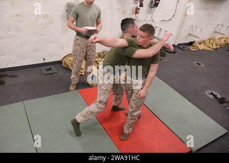 US military forces. 180309DL117-0019 MEDITERRANEAN SEA (March 9, 2018) Marine Lance Cpl. Justin Heimbach, left, a mortarman assigned to Battalion Landing Team, 2nd Battalion, 6th Marine Regiment, 26th Marine Expeditionary Unit (MEU), conducts a side choke technique on Marine Lance Cpl. Logan Terry, a mortarman with the unit, during a Marine Corps Martial Arts Program (MCMAP) green belt advancement class aboard the San Antonio-class amphibious transport dock USS New York (LPD 21) March 9, 2018. MCMAP teaches Marines techniques they can utilize in hand-to-hand combat to increase their lethality Stock Photo