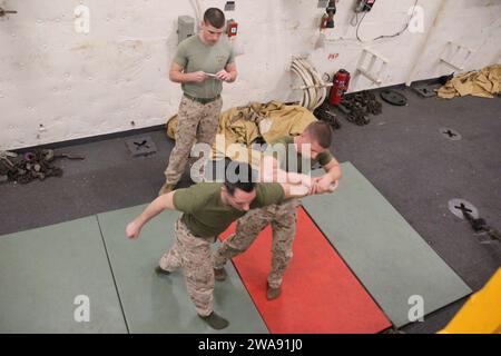 US military forces. 180309DL117-0014 MEDITERRANEAN SEA (March 9, 2018) Marine Lance Cpl. Logan Terry, right, a mortarman assigned to Battalion Landing Team, 2nd Battalion, 6th Marine Regiment, 26th Marine Expeditionary Unit (MEU), conducts an arm-bar take down technique on Marine Lance Cpl. Justin Heimbach, a mortarman with the unit, during a Marine Corps Martial Arts Program (MCMAP) green belt advancement class aboard the San Antonio-class amphibious transport dock USS New York (LPD 21) March 9, 2018. MCMAP teaches Marines techniques they can utilize in hand-to-hand combat to increase their l Stock Photo