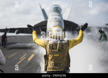 US military forces. 180320MT837-0068  PACIFIC OCEAN (March 20, 2018) Aviation Boatswain’s Mate (Handling) 3rd Class Emily Westfall directs the crew of an F/A-18F Super Hornet assigned to the Bounty Hunters of Strike Fighter Squadron (VFA) 2 on the flight deck of the Nimitz-class aircraft carrier USS Carl Vinson (CVN 70). The Carl Vinson Cariier Strike Group is operating in the western Pacific as part of a scheduled deployment. (U.S. Navy photo by Mass Communication Specialist 3rd Class Dylan M. Kinee/Released) Stock Photo