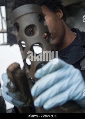 US military forces. 180323RG482-169 ATLANTIC OCEAN (March 23, 2018) Gunner's Mate Seaman Apprentice Alexia Morgan performs maintenance on a .50-caliber machine gun aboard the Arleigh Burke-class guided-missile destroyer USS Ross (DDG 71) March 23, 2018. Ross, forward-deployed to Rota, Spain, is on its sixth patrol in the U.S. 6th Fleet area of operations in support of regional allies and partners and U.S. national security interests in Europe. (U.S. Navy photo by Mass Communication Specialist 1st Class Kyle Steckler/Released) Stock Photo