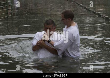 US military forces. 180324KP946-023 KVUTZAT KINNERET, Israel (March 24, 2018) Lt. Ethan Everts, right, a chaplain assigned to the Arleigh Burke-class guided-missile destroyer USS Donald Cook (DDG 75), baptizes Boatswain's Mate 1st Class Mario Chambergo, from North Plainfield, New Jersey, in the Jordan River March 24, 2018. Donald Cook, forward-deployed to Rota, Spain, is on its seventh patrol in the U.S. 6th Fleet area of operations in support of regional allies and partners, and U.S. national security interests in Europe and Africa. (U.S. Navy photo by Mass Communication Specialist 2nd Class Stock Photo