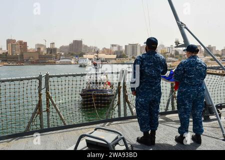 US military forces. 180405QR145-029 DAKAR, Senegal (April 5, 2018) Ship's Serviceman 1st Class James Terry, left, and Ship's Serviceman 2nd Class Sarah Brooks prepare to raise the American flag aboard the Blue Ridge-class command and control ship USS Mount Whitney (LCC 20) as the ship arrives in Dakar, Senegal, April 5, 2018. Mount Whitney, forward-deployed to Gaeta, Italy, operates with a combined crew of U.S. Navy Sailors and Military Sealift Command civil service mariners. (U.S. Navy photo by Mass Communication Specialist 3rd Class Krystina Coffey/Released) Stock Photo