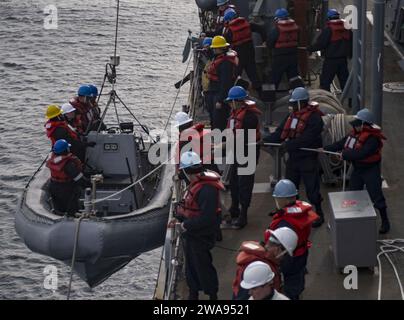 US military forces. 180501RG482-191 NORTH SEA (May 1, 2018) Sailors aboard the Arleigh Burke-class guided-missile destroyer USS Ross (DDG 71) recover a rigid-hull inflatable boat while participating in exercise Joint Warrior 18-1 May 1, 2018. Joint Warrior is a U.K.-led, multinational exercise that exercises interoperability and cooperation in all applicable warfare areas. (U.S. Navy photo by Mass Communication Specialist 1st Class Kyle Steckler/Released) Stock Photo