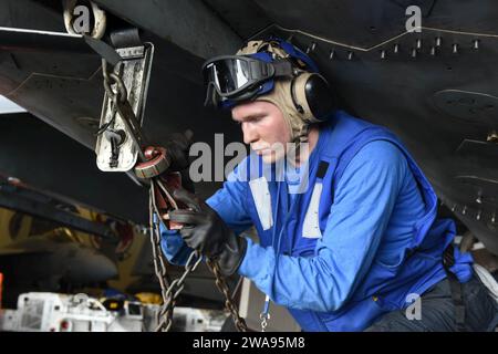 US military forces. 180506ZH683-0120 MEDITERRANEAN SEA (May. 6, 2018) Aviation Boatswain's Mate (Handling) Airman Sean Blish secures a chain onto an F/A-18F 'Super Hornet' in the hangar bay aboard the Nimitz-class aircraft carrier USS Harry S. Truman (CVN 75). As the Carrier Strike Group 8 flag ship, Truman's support of Operation Inherent Resolve demonstrates the capability and flexibility of U.S. Naval Forces, and its resolve to eliminate the terrorist group ISIS and the threat it poses. (U.S. Navy photo by Mass Communication Specialist 3rd Class Juan Sotolongo/Released) Stock Photo