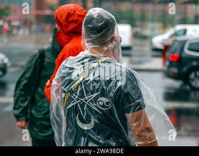 Tourists with rain capes and umbrellas during heavy rainfall, 23.06.2023 Stock Photo
