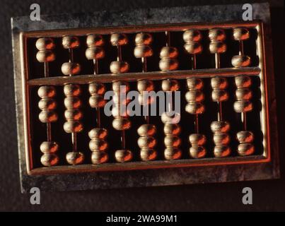 CLOSE-UP OF A SMALL CHINESE ABACUS ALSO KNOWN AS A COUNTING FRAME OR MANUAL CALCULATOR. Stock Photo
