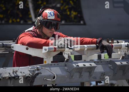 US military forces. 180702EA818-0291 ATLANTIC OCEAN (July 2, 2018) Aviation Ordnanceman 3rd Class Zachary Andrew, assigned to the 'Fighting Checkmates' of Strike Fighter Squadron (VFA) 211, stands by to load an ordinance rack onto an F/A-18F Super Hornet on. The flight deck aboard the Nimitz-class aircraft carrier USS Harry S. Truman (CVN 75). Harry S. Truman is currently deployed as part of an ongoing rotation of U.S. forces supporting maritime security operations in international waters around the globe. (U.S. Navy photo by Mass Communication Specialist 2nd Class Thomas Gooley/Released) Stock Photo