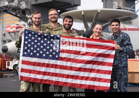 US military forces. 180708ZH683-0166 ATLANTIC OCEAN (July 8, 2018) Sailors pose for a photo on the flight deck during a steel beach picnic aboard the Nimitz-class aircraft carrier USS Harry S. Truman (CVN 75). Harry S. Truman is currently deployed as part of an ongoing rotation of U.S. forces supporting maritime security operations in international waters around the globe. (U.S. Navy photo by Mass Communication Specialist 3rd Class Juan Sotolongo/Released) Stock Photo