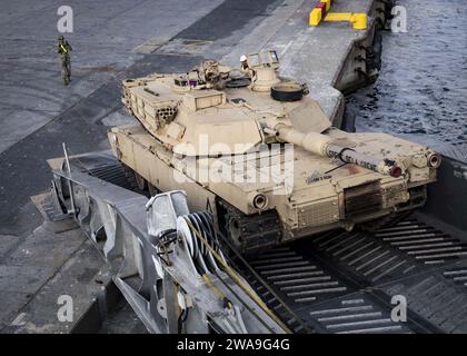 US military forces. CONSTANTA, Romania (Aug. 24, 2018) A U.S. Army Soldier assigned to Bravo Company, 2nd Battalion, 5th Cavalry Regiment, 1st Armored Brigade Combat Team, 1st Cavalry Division directs an M1A1 Abrams tank down the stern ramp of the Spearhead-class expeditionary fast transport ship USNS Carson City (T-EPF 7) in Constanta, Romania, Aug. 24, 2018. Carson City is the seventh of nine expeditionary fast transport ships in Military Sealift Command's inventory with a primary mission of providing rapid transport of military equipment and personnel in theater via its 20,000 square foot r Stock Photo