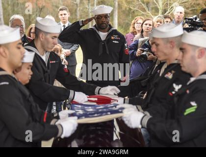US military forces. 181207CH038-272 KILMICHAEL, Miss. (Dec. 7, 2018) Air Traffic Controller 1st Class Jonathan Epperson renders a salute as Sailors  assigned to the Naval Air Station Meridian Honor Guard fold the American flag above the casket of Aviation Machinist's Mate 2nd Class Durell Wade at the North Mississippi Veterans Memorial Cemetery in Kilmichael, Miss, Dec. 7, 2018. Wade, a Mississippi native, died aboard the battleship USS Oklahoma (BB 37) during the Dec. 7, 1941 Japanese attack on Pearl Harbor. Wade's remains were recently identified through the Defense POW/MIA Accounting Agency Stock Photo