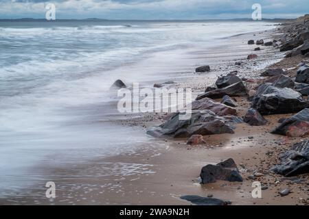 Rocks and sea on Findhorn beach in the winter. Findhorn, Morayshire Scotland. Long Exposure Stock Photo