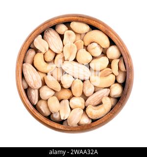 Mixed nuts, roasted and salted nut mix, in a wooden bowl. Snack food, consisting of peanuts, hazelnuts, cashews, and blanched almonds. Stock Photo