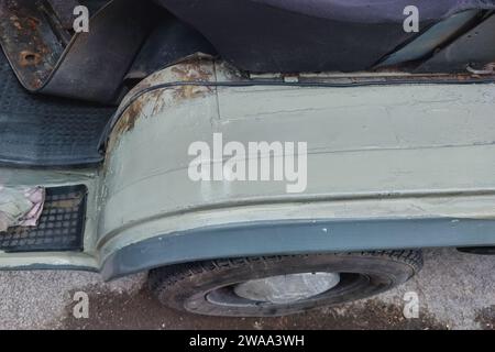 Welding a car or van inner fender. Repairing rust holes, removing rusty metal and painting it back. Step six - final paint on the surface in car color Stock Photo