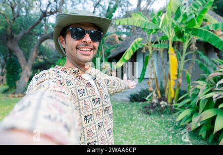 happy man taking selfie photo during summer tropical vacation - Vacation and tourism concept Stock Photo