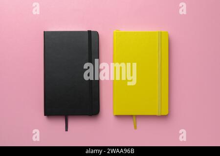 Different notebooks on light pink background, top view Stock Photo
