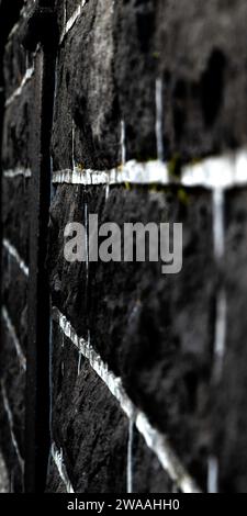 Detail of a black and white brick wall, a geometric and minimalist image that represents the elegance of simplicity. Perspective image. Selective focu Stock Photo