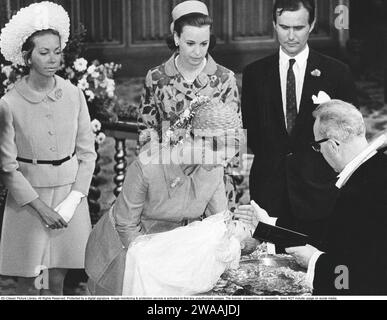 Prince Joachim of Denmark. Born in 1969 and the youngest son of Queen Margarethe and Prince Henrik. Here from the baptism in Aarhus Cathedral on July 15, 1969, where Margrethe holds him in front of the baptismal font and the priest baptizes him as Joachim Holger Waldemar Christian. Swedish Princess Christina and Danish Princess Benedikte attend as godparents. Stock Photo