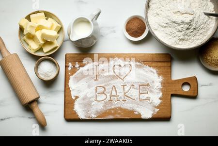 various baking tools and flour on pink napkin, top view, I love bake Stock Photo