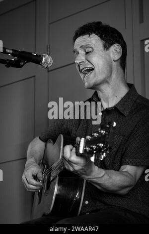 Gerry Love, Formerly of Teenage Fanclub, and Lightships, performing at the Strathaven Hotel outside Glasgow in 2022. He is playing an accoustic guitar Stock Photo