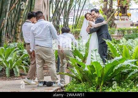 A newly married couple being photographed at their wedding in Bangkok, Thailand. Stock Photo