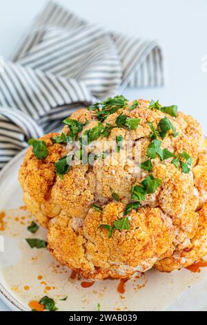 Roasted whole spicy cauliflower with tahini dressing Stock Photo - Alamy