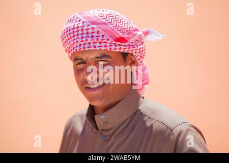 A local guide of the Wadi Rum desert wearing a traditional 'Keffiyeh' (or kefiah) Arabic headdress turban, Jordan, Middle East. Stock Photo