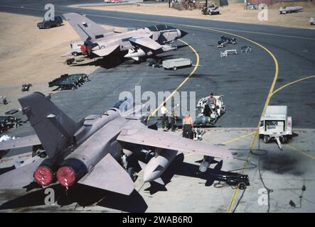 20th Jan 1991 During the air-war, ground crew arm RAF Tornado GR1 jets with bombs at the King Faisal Airbase, Tabuk, Saudi Arabia. Stock Photo