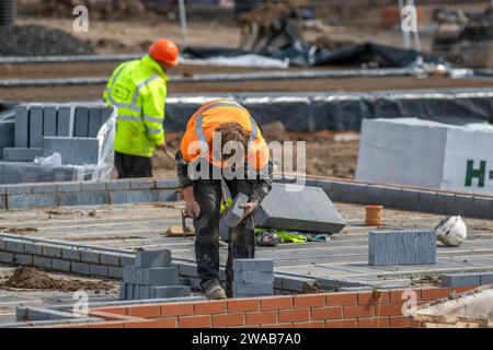 Stages of construction; Farington Mews Keepmoat homes property developers. Bricklayers build foundations for 520 new houses at a development site in Chorley. Builders Start construction on this large new housing estate using Lynx precast concrete flooring systems. UK Stock Photo