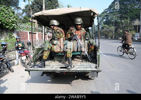 Dhaka Bangladesh 03rd Jan 2024 A Member Of Bangladesh Army Stands   Dhaka Bangladesh 03rd Jan 2024bangladesh Army Personnel Sit In The Back Of A Vehicle In Dhaka Bangladesh On January 3 2024 To Assist Local Administrations Ahead Of The Upcoming General Election On January 7 The Armed Forces Are Being Deployed Nationwide In Preparation For The 12th National Parliamentary Election Credit Mamunur Rashidalamy Live News 2wab9y5 