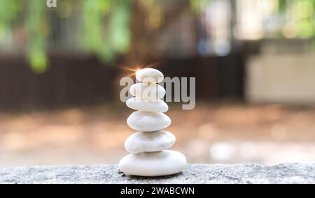 Build pebble stack on the sea shore on hand copy space and natural pebble stone beautiful. Concentration, balanced body, spirit, soul and relaxation c Stock Photo