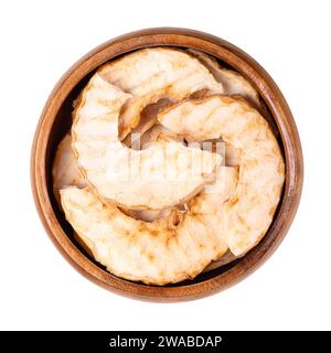 Riffled apple chips, a healthy snack, in a wooden bowl. Dehydrated, wavy cut apple slices, sweet chips or crisps with a dense and crispy texture. Stock Photo