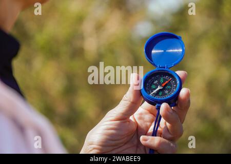Close-up of a person using a compass outdoors during a trekking in the mountain Stock Photo