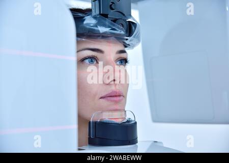 Woman patient make a dental computer tomograph in clinic. Dentistry and health care concept. Stock Photo