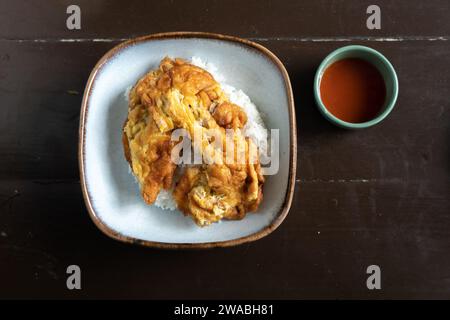 Thai style Rice with omelet stuff minced pork, street food of thailand call khao kai jeaw moo sab, Top view table. Omelet on white rice , Thai minced Stock Photo