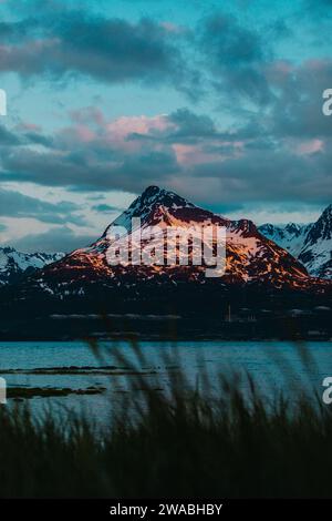 Sunset bursting with colors over lakeside mountains in Alaska. Stock Photo
