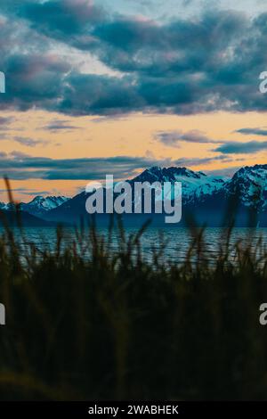 Sunset bursting with colors over lakeside mountains in Alaska. Stock Photo