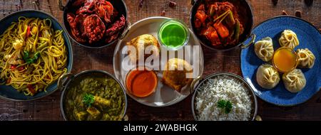 Composition with indian dishes: samosa, pakora, palak paneer, jalfrezi, thukpa and naan bread Stock Photo