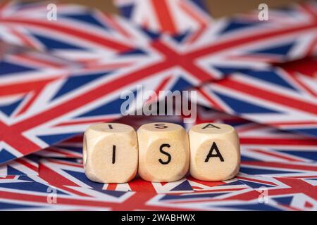 ISA, I S A , letters on wooden dice on a background of Union Jack paper, United Kingdom Individual Savings Account, investment, New Financial Year Stock Photo