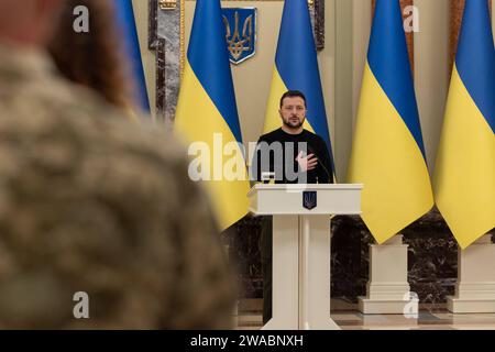 Ukrainian President Volodymyr Zelenskyy presents certificates to the apartment allocated to soldiers who took part in the Russia-Ukraine war Ukrainian President Volodymyr Zelenskyy presents certificates to the apartment allocated to soldiers who took part in the Russia-Ukraine war and families of fallen Heroes during a ceremony at the Mariinsky Palace in Kyiv, Ukraine on January 03, 2023. As part of the Head of State s initiative to provide housing for the soldiers of the Heroes of Ukraine, Zelenskyy presented certificates of obtaining apartments to the Heroes of Ukraine and the family members Stock Photo