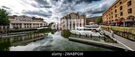 Boats And Ships In St Katharine Docks With Office Buildings And Restaurants In London, United Kingdom Stock Photo