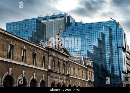 Old Historic Building In Front Of Modern Office Building With Blue Glass Facade In The Finance District Of London, United Kingdom Stock Photo