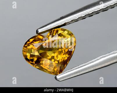 natural yellow chrysobeyl gem on background Stock Photo