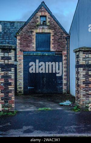 Old garage or coachhouse with a storeroom above and a winch. Llandaff, Wales. Stock Photo