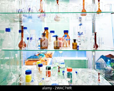 Laboratory glass dishes, bottles, jars and flasks in store Stock Photo