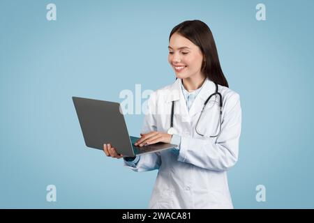 Focused doctor using laptop, technology in healthcare Stock Photo