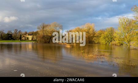 Flooded river Avon at Lacock Wiltshire after storm Henk with the abbey in the background. Stock Photo
