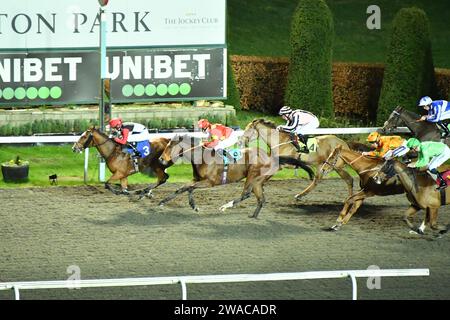 London, UK. 3rd January 2023. Liseo (red cap), ridden by Ross Coakley, wins the 19.30 Unibetsupport safe gambling handicap Stakes, ahead of God of Thunder (orange and yellow spotted cap), ridden by Liam Keniry, at Kempton Park Racecourse, UK. Credit: Paul Blake/Alamy Live News. Stock Photo